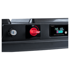 Black electrical panel with red switch and digital display on a white background